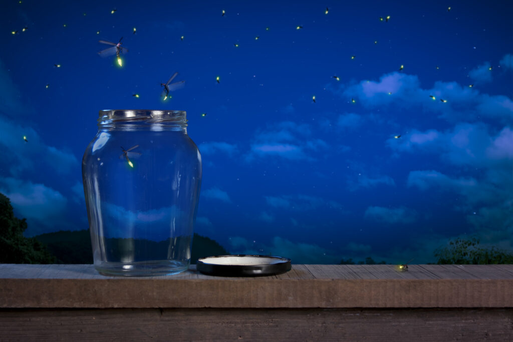 Fireflies escape open jar on wooden beam into cloudy night